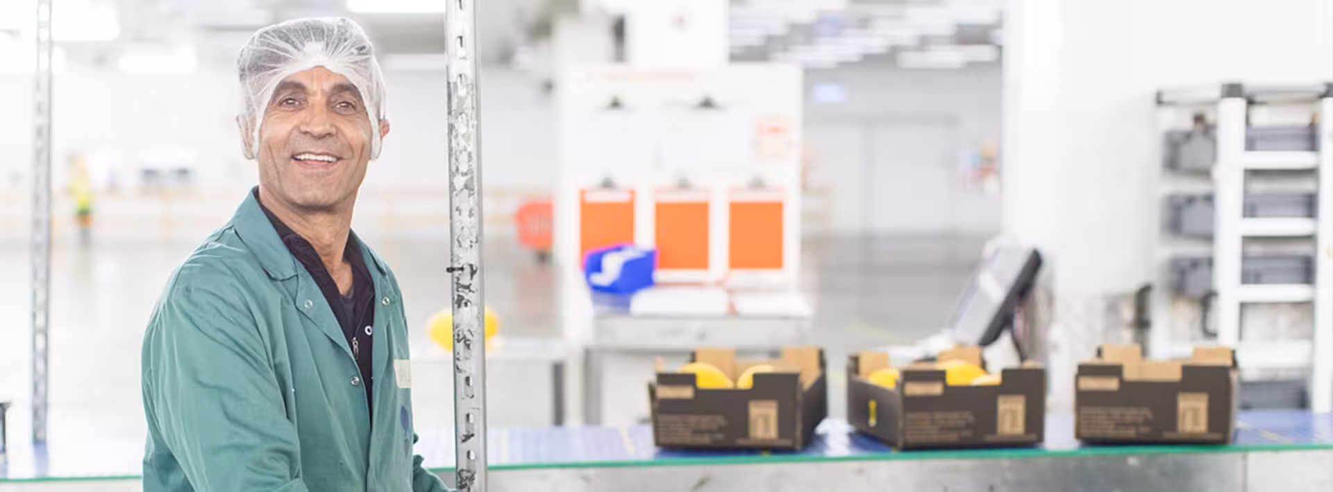 Man in fruit processing warehouse smiles