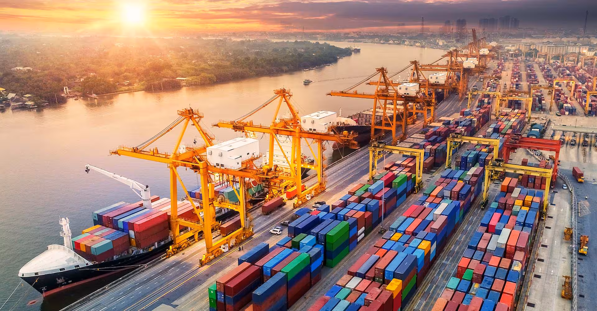 Large docks at sunset with ships and containers