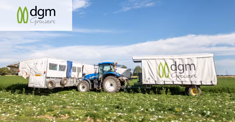 Tractor in a field with a dgm growers trailer